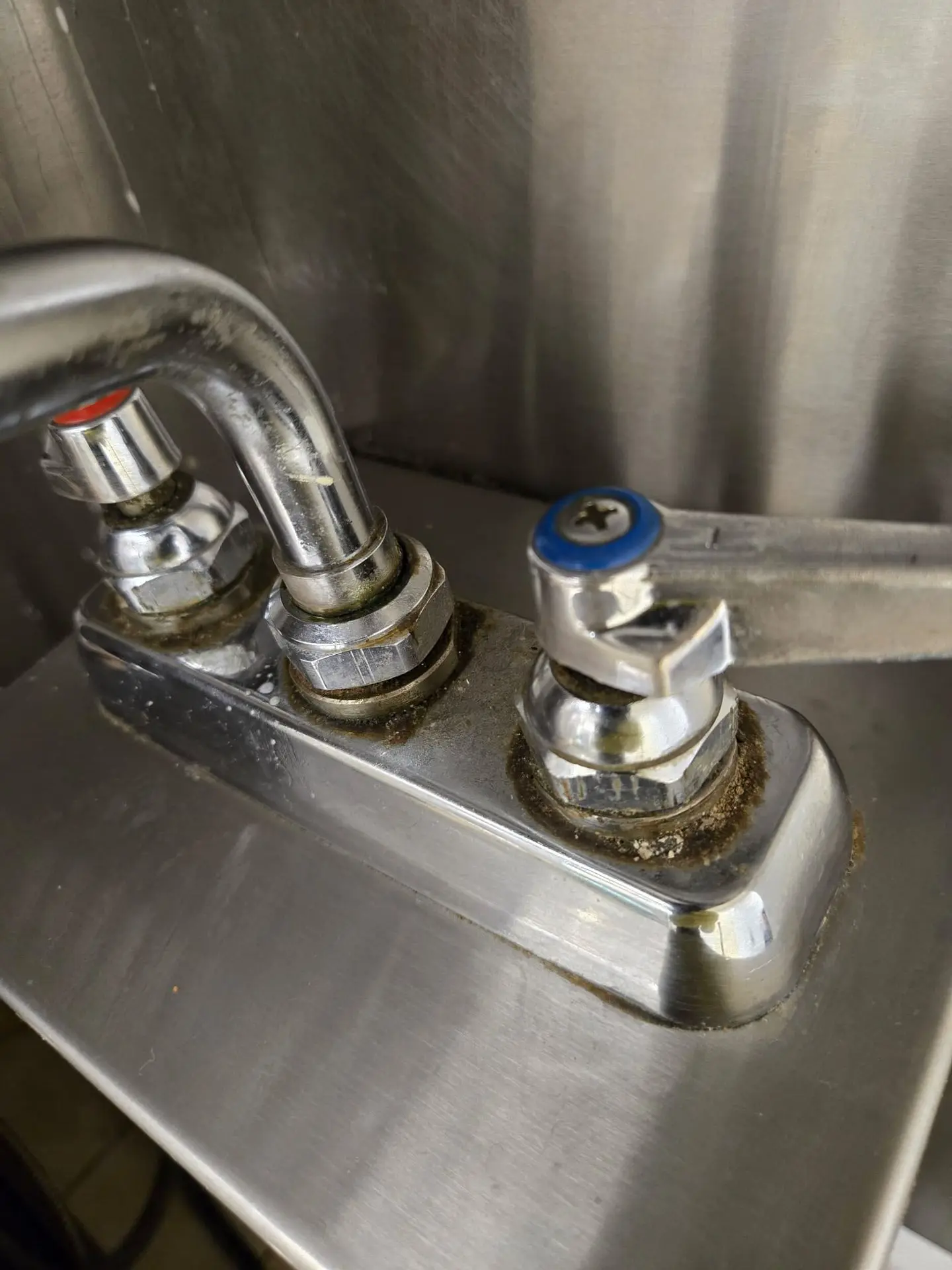 Commercial kitchen stainless with heavy grease buildup before KL Cleaning Edmonton