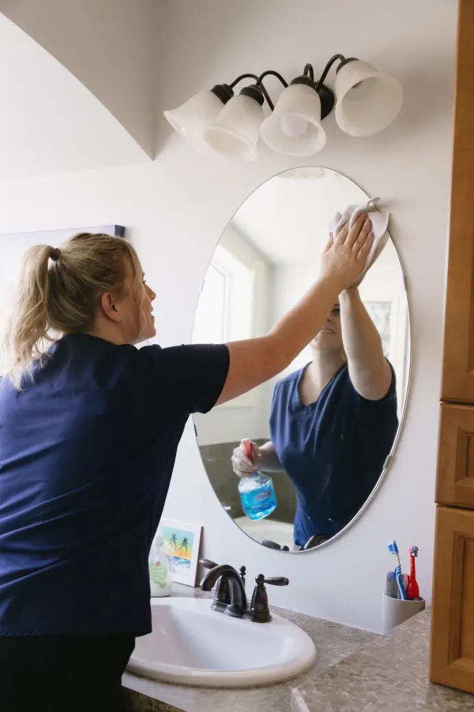 Recurring Clean KL Cleaning worker cleaning bathroom mirror
